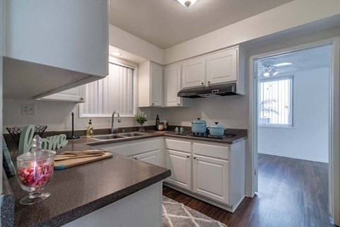 a kitchen with a sink and a window at Park Avenue Apartments, Long Beach ,90815